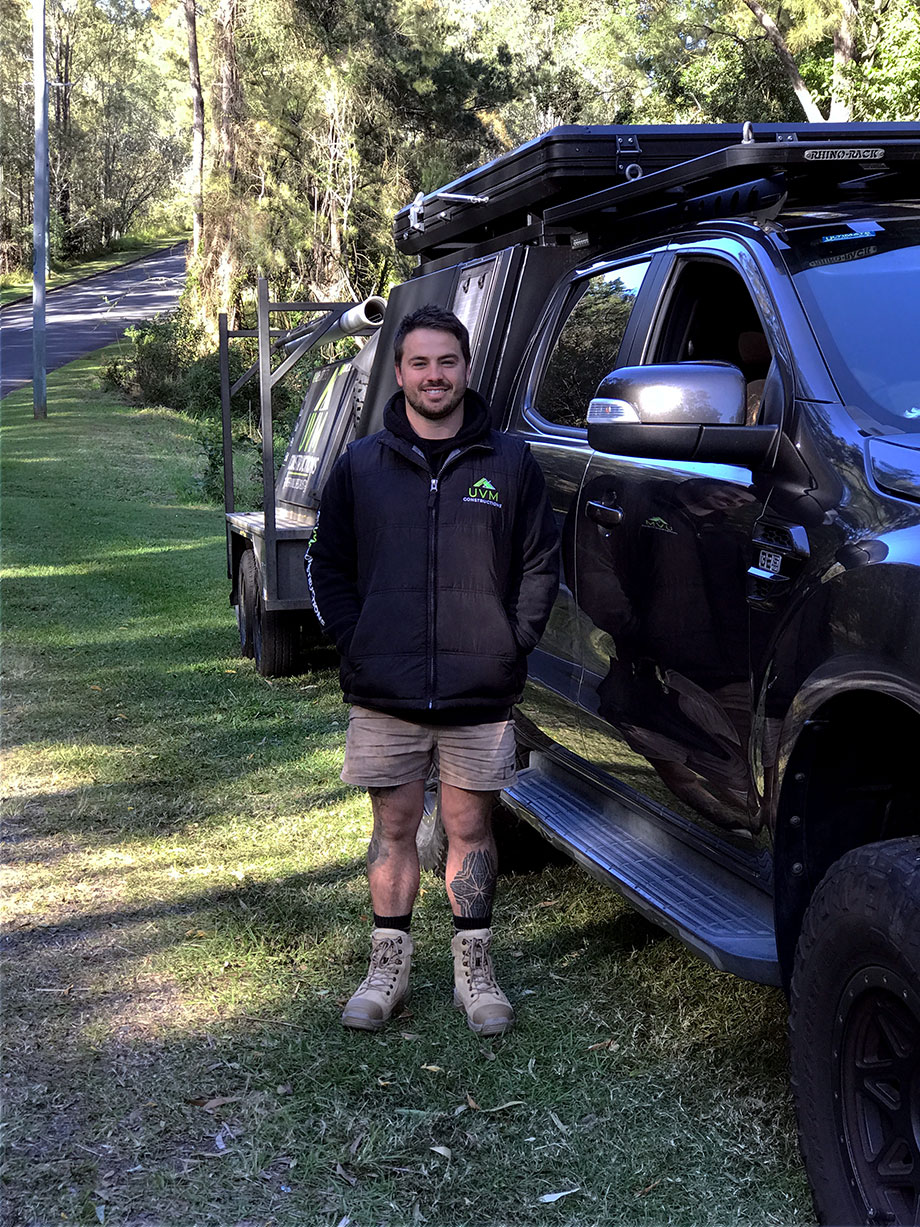 Carpenter Uther Mottershead standing next to his work ute in Karana Downs.